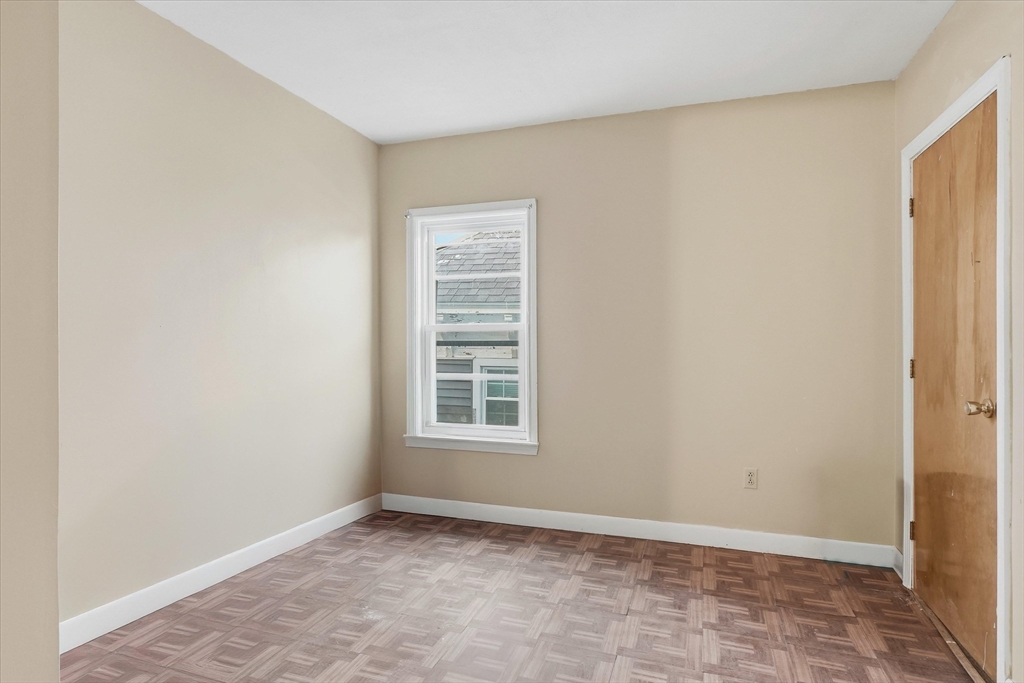494 Fletcher Street Lowell, MA 01854 - Photo 19 of 29 a view of an empty room with a window