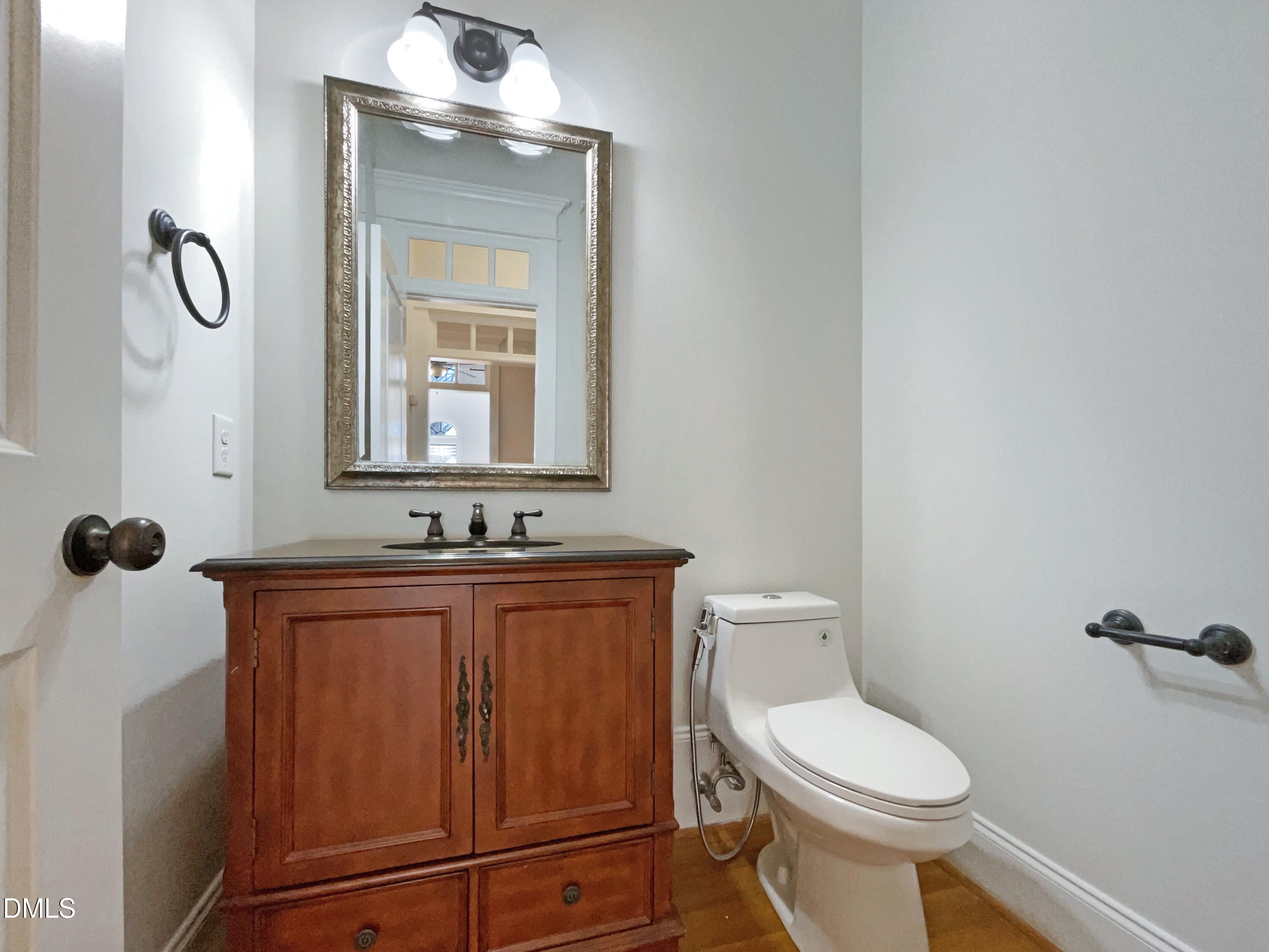 1703 Happiness Hill Lane Raleigh, NC 27614 - Photo 14 of 30 a bathroom with a toilet sink and mirror