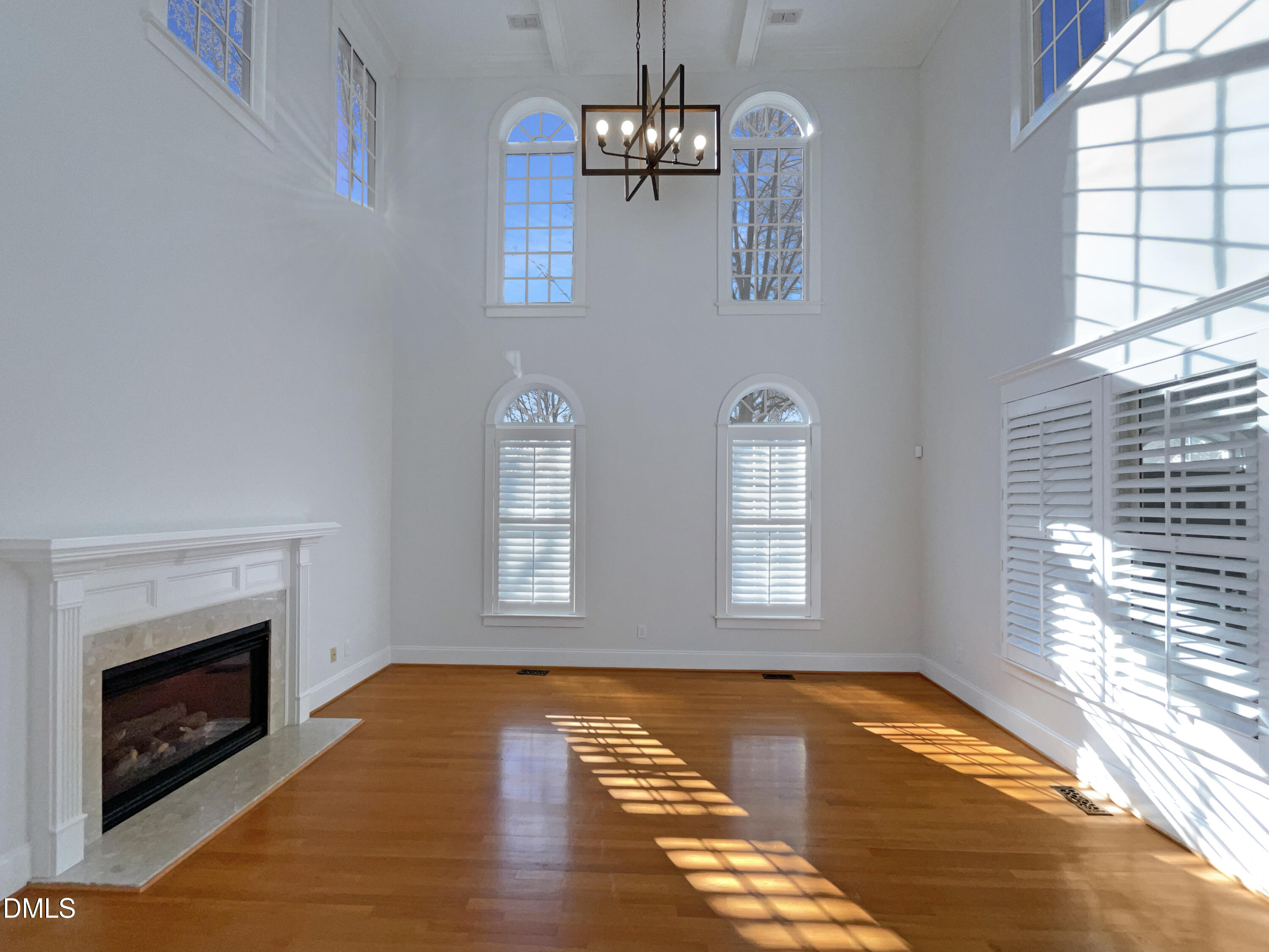 1703 Happiness Hill Lane Raleigh, NC 27614 - Photo 3 of 30 a view of empty room with wooden floor and fireplace