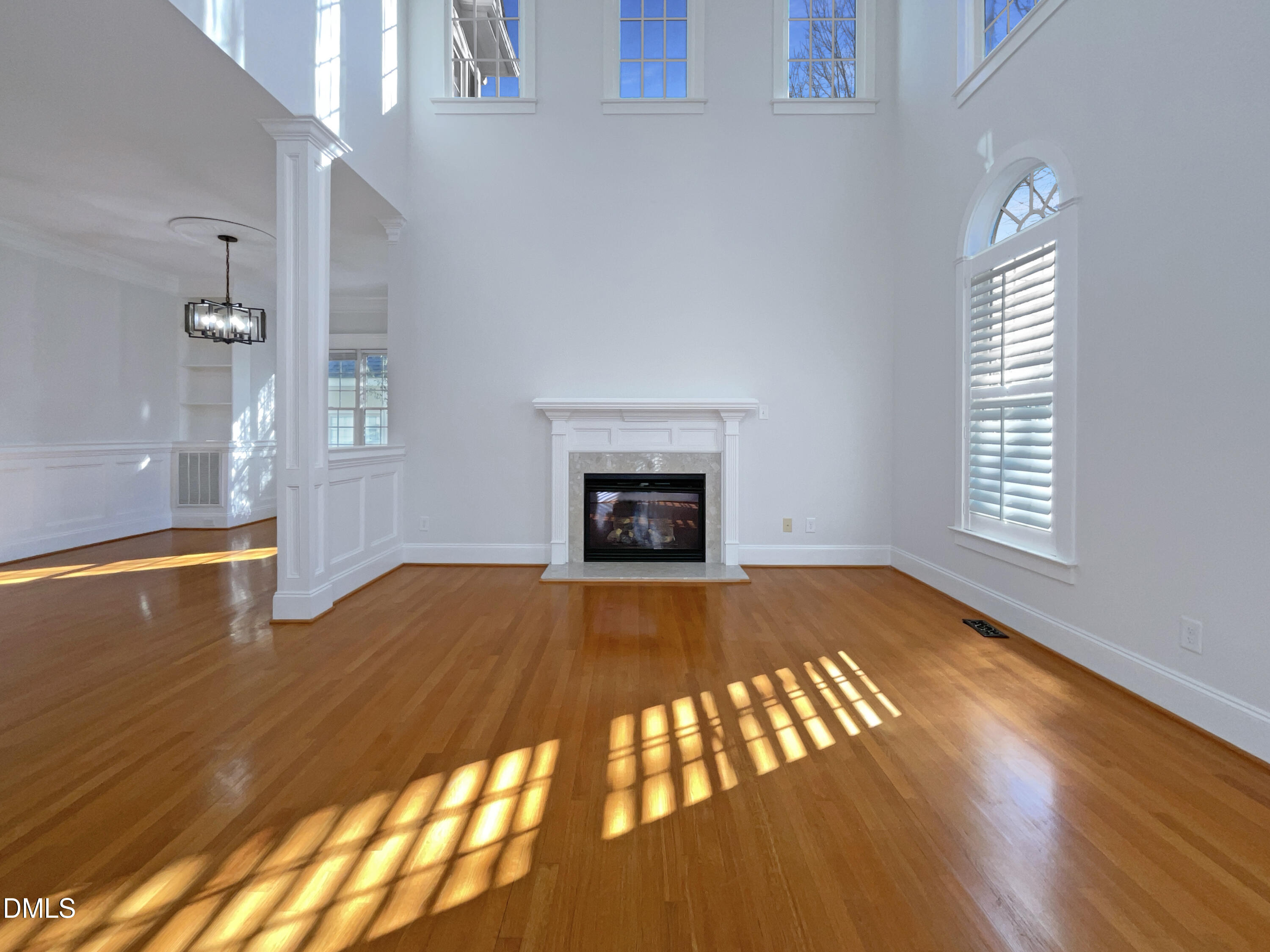1703 Happiness Hill Lane Raleigh, NC 27614 - Photo 7 of 30 a view of an empty room with wooden floor and a window