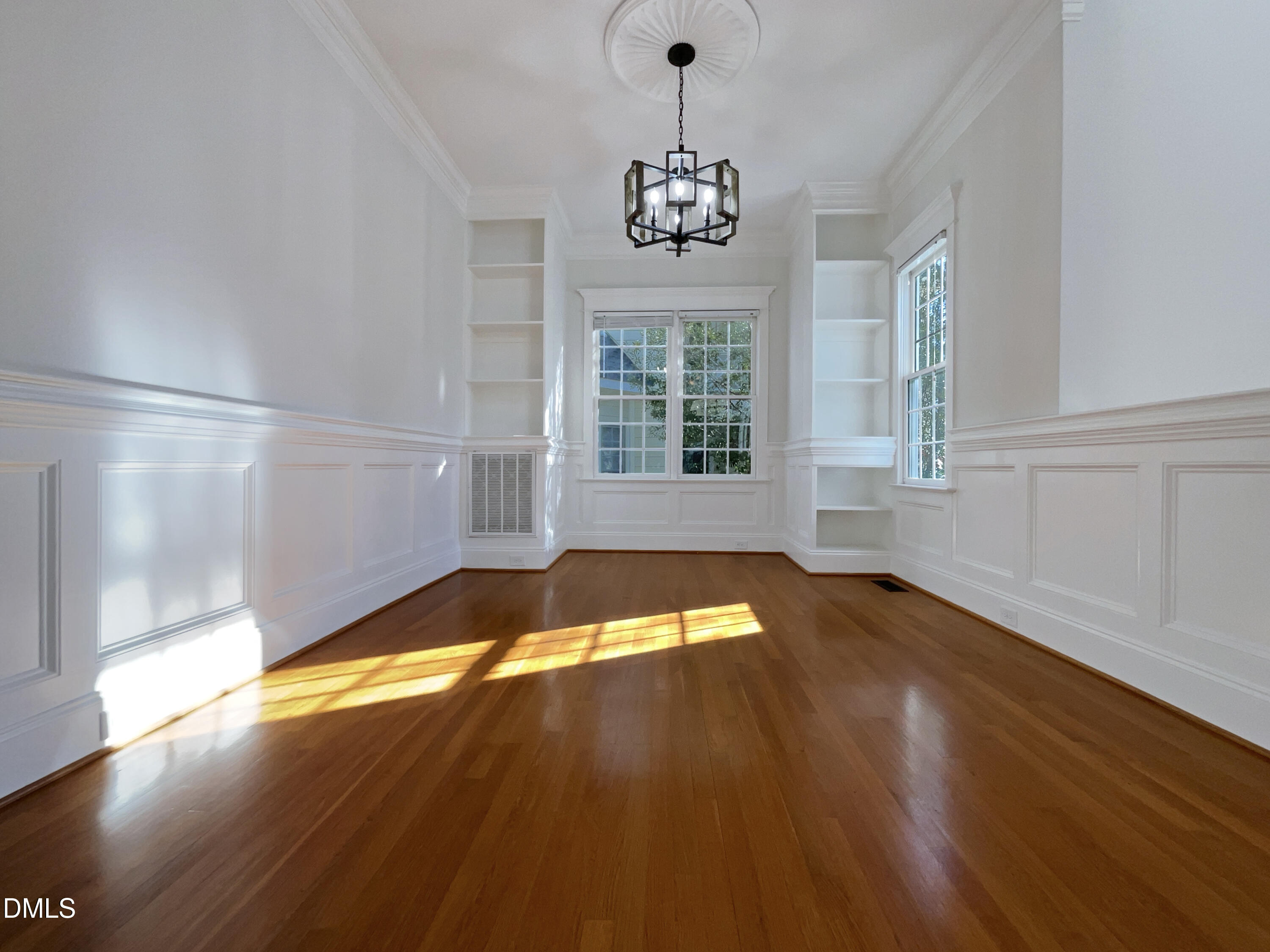 1703 Happiness Hill Lane Raleigh, NC 27614 - Photo 8 of 30 a view of an empty room with a window and wooden floor