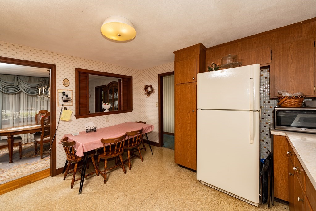 46 Pilgrim Road Braintree, MA 02184 - Photo 19 of 35 a dining room with furniture and a refrigerator