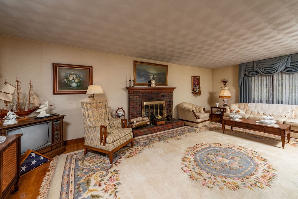 46 Pilgrim Road Braintree, MA 02184 - Photo 23 of 35 a living room with furniture a rug and a flat screen tv
