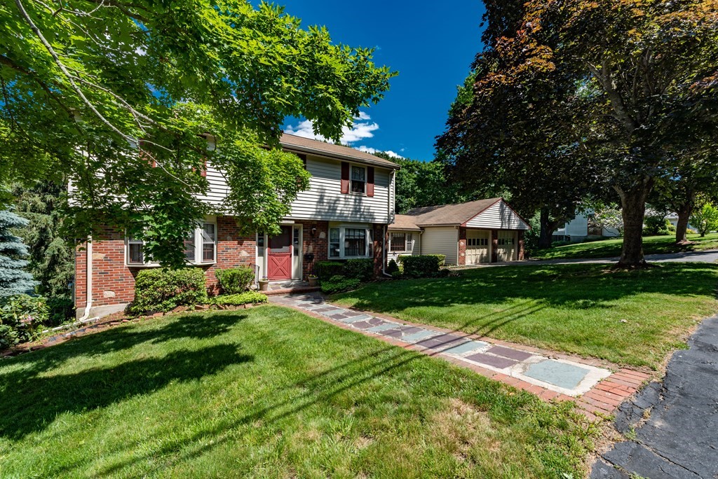 46 Pilgrim Road Braintree, MA 02184 - Photo 5 of 35 a front view of a house with a yard table and chairs