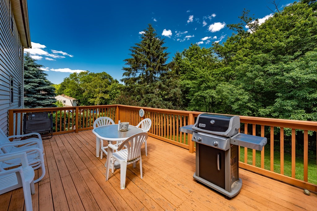 46 Pilgrim Road Braintree, MA 02184 - Photo 9 of 35 a balcony with wooden floor table and chairs