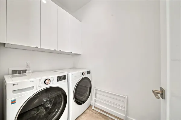 a living room with stainless steel appliances kitchen island furniture and a view of kitchen