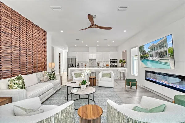 a living room with patio furniture and a large window