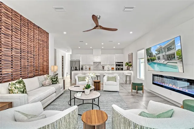 a living room with patio furniture and a large window