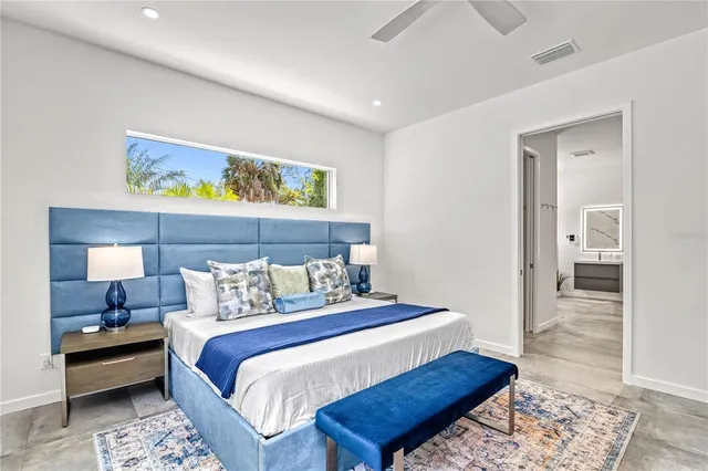 a spacious bathroom with a bathtub sink mirror and window