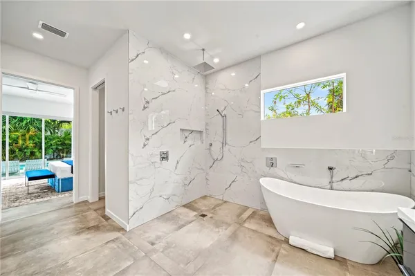 a white toilet sitting next to a white wall