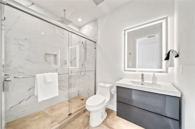 a bedroom with a bed and painting on the wall