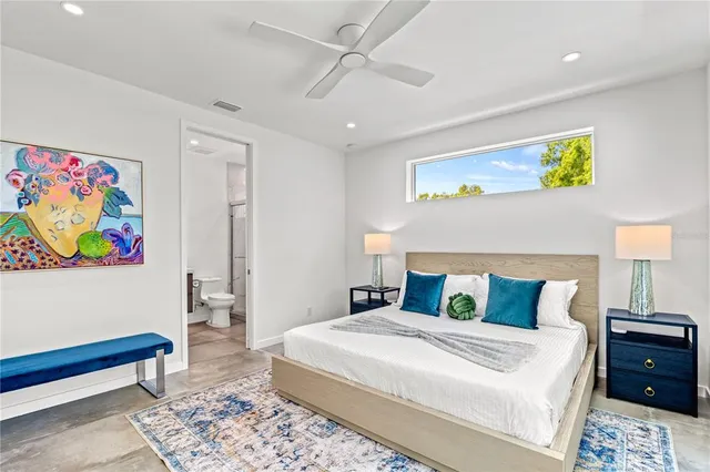 a bedroom that has a bed and a chandelier