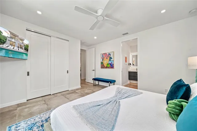 a bedroom with a large bed and a window