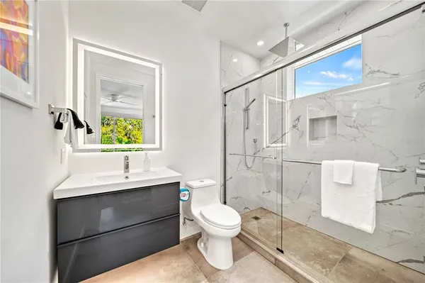 a bedroom with a bed and ceiling fan