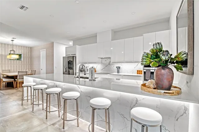 a kitchen with a sink white cabinets and stainless steel appliances