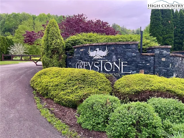 a view of a garden with a fountain in the background