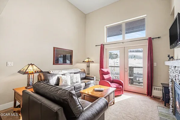 a living room with furniture and a lamp