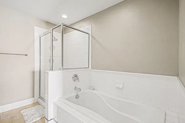 a bathroom with a bathtub and a shower