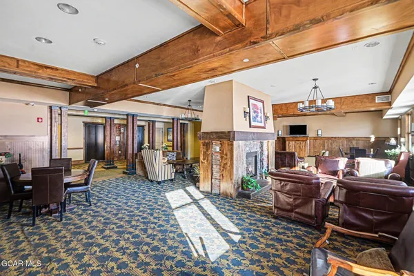 a living room with lots of furniture and a ceiling fan