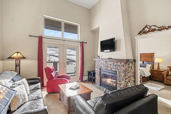 a living room with furniture a flat screen tv and a fireplace