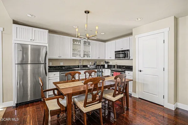 a kitchen with stainless steel appliances granite countertop a refrigerator and a stove top oven