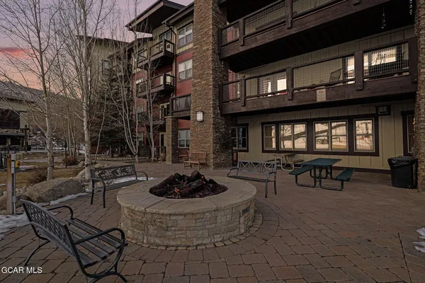 a building outdoor space with patio furniture and a potted plant