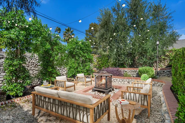 a view of a backyard with a tree