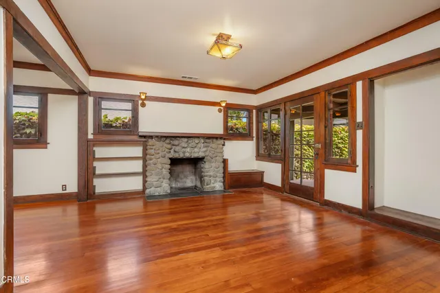 a view of a room with wooden floor and furniture