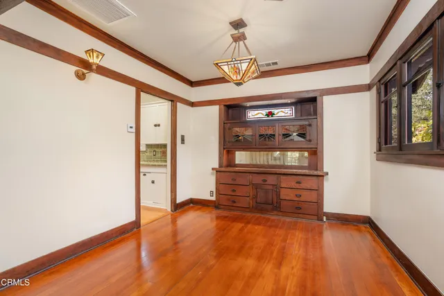 a view of empty room with fireplace and window