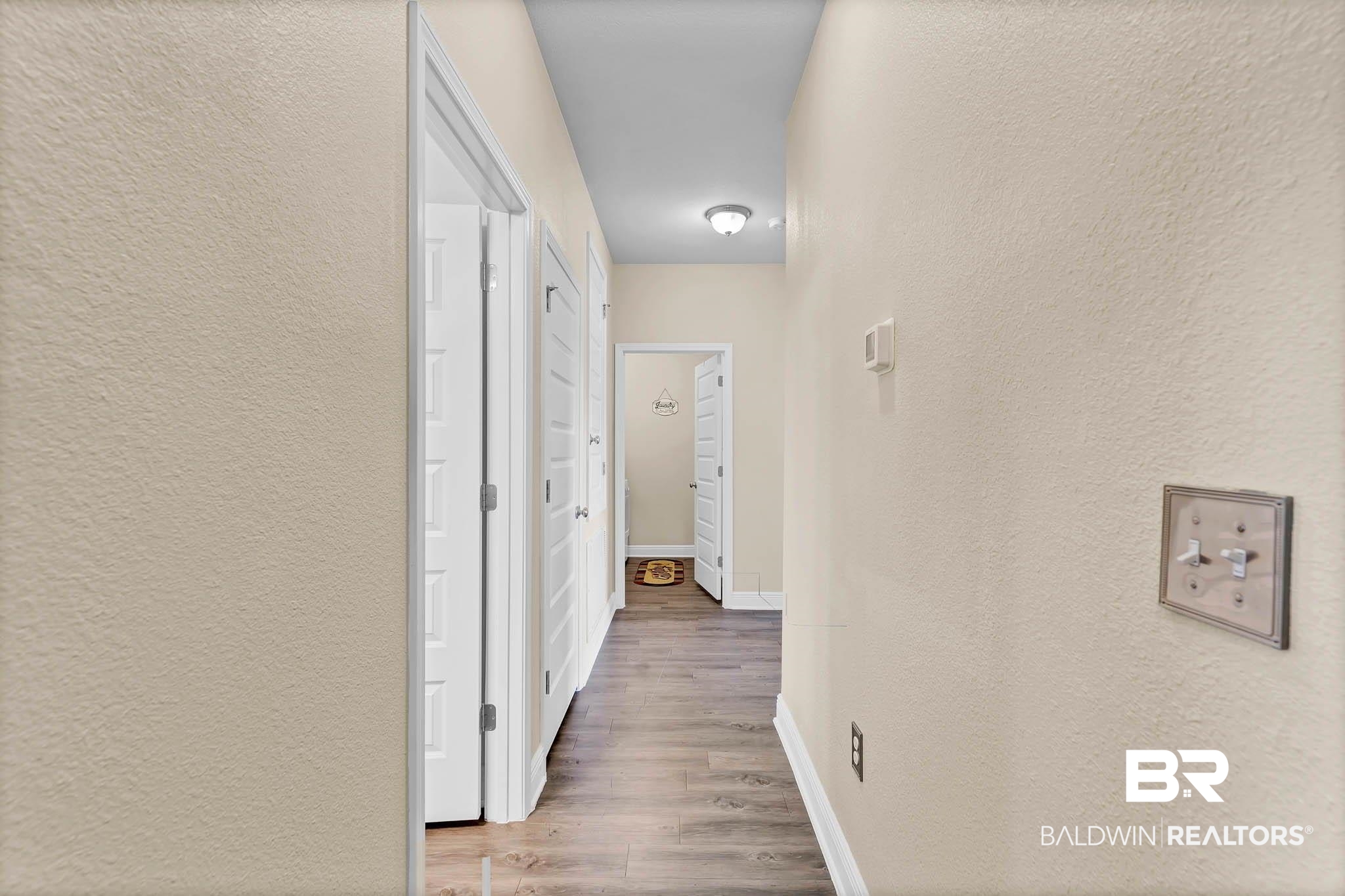 2049 Bourbon Street Foley, AL 36535 - Photo 26 of 56 Hall featuring a textured wall and wood finished floors