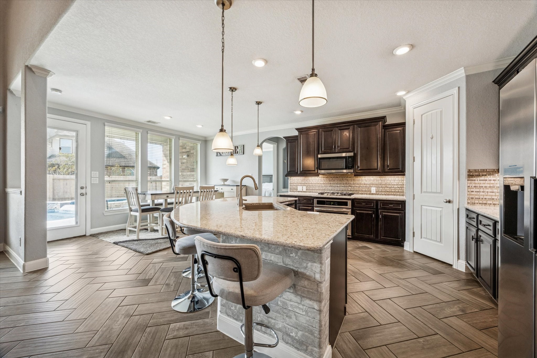 2283 Rising Bay Court League City, TX 77573 - Photo 11 of 45 The kitchen is open to the breakfast room and you can enjoy a view of the pool while you cook!