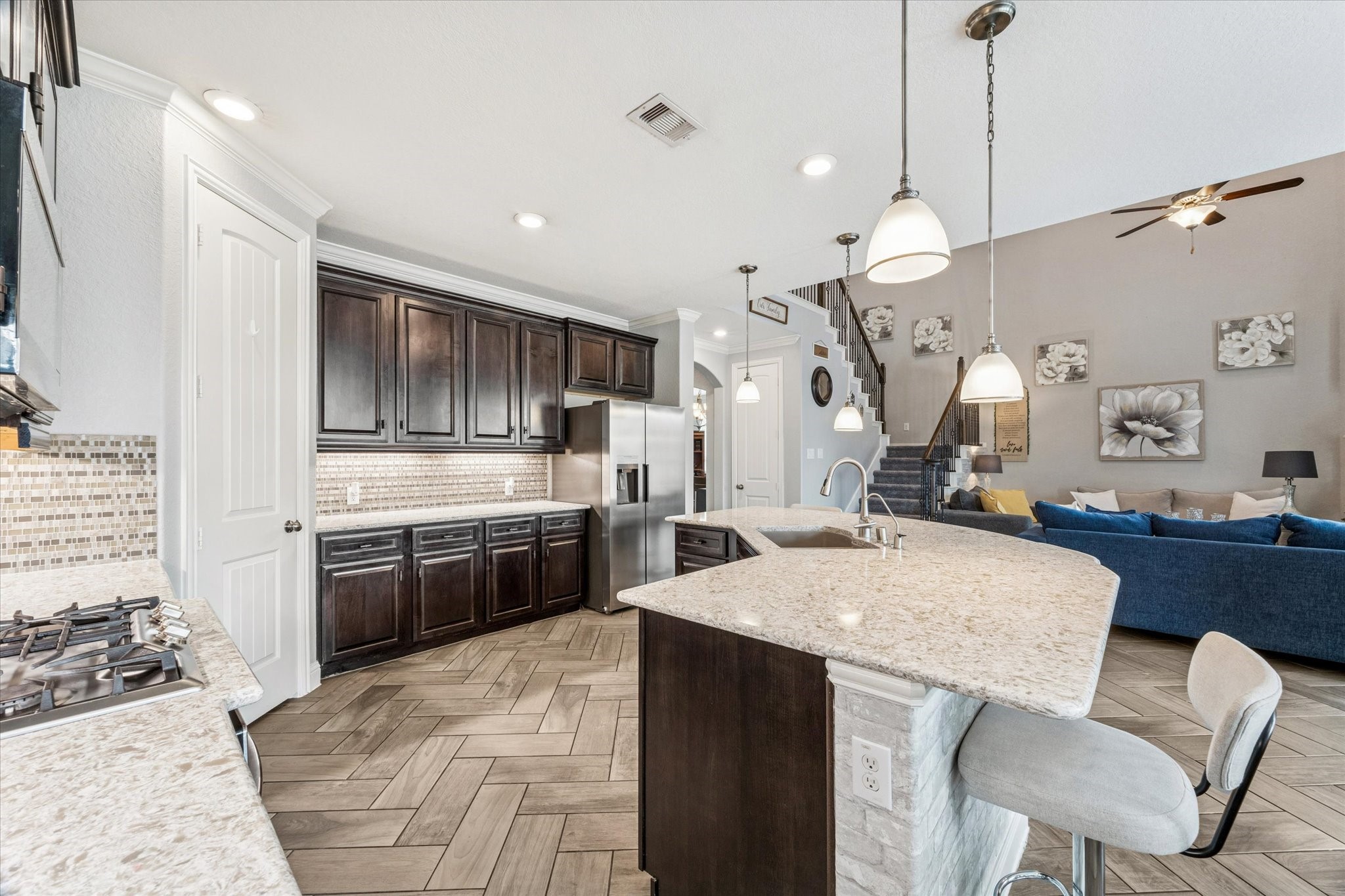 2283 Rising Bay Court League City, TX 77573 - Photo 14 of 45 a kitchen with stainless steel appliances kitchen island granite countertop a sink a stove and a refrigerator