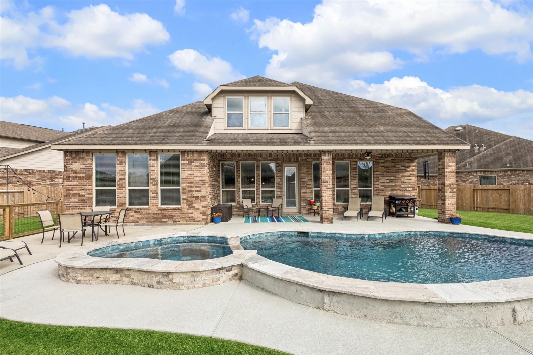 2283 Rising Bay Court League City, TX 77573 - Photo 2 of 45 a view of a house with sitting area and swimming pool