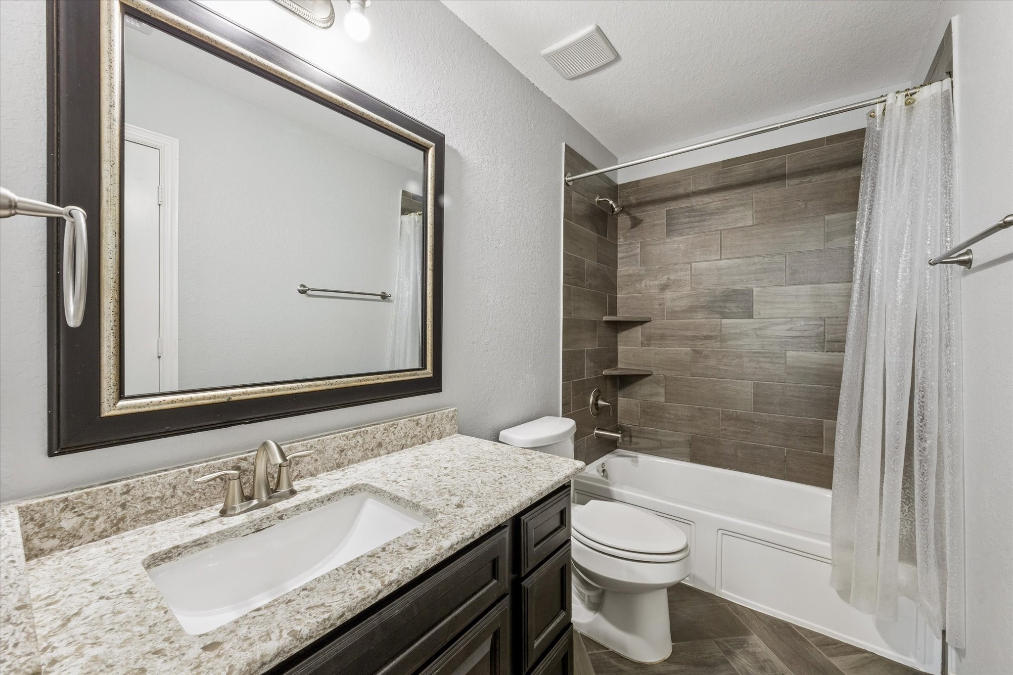 2283 Rising Bay Court League City, TX 77573 - Photo 29 of 45 a bathroom with a granite countertop sink toilet and shower