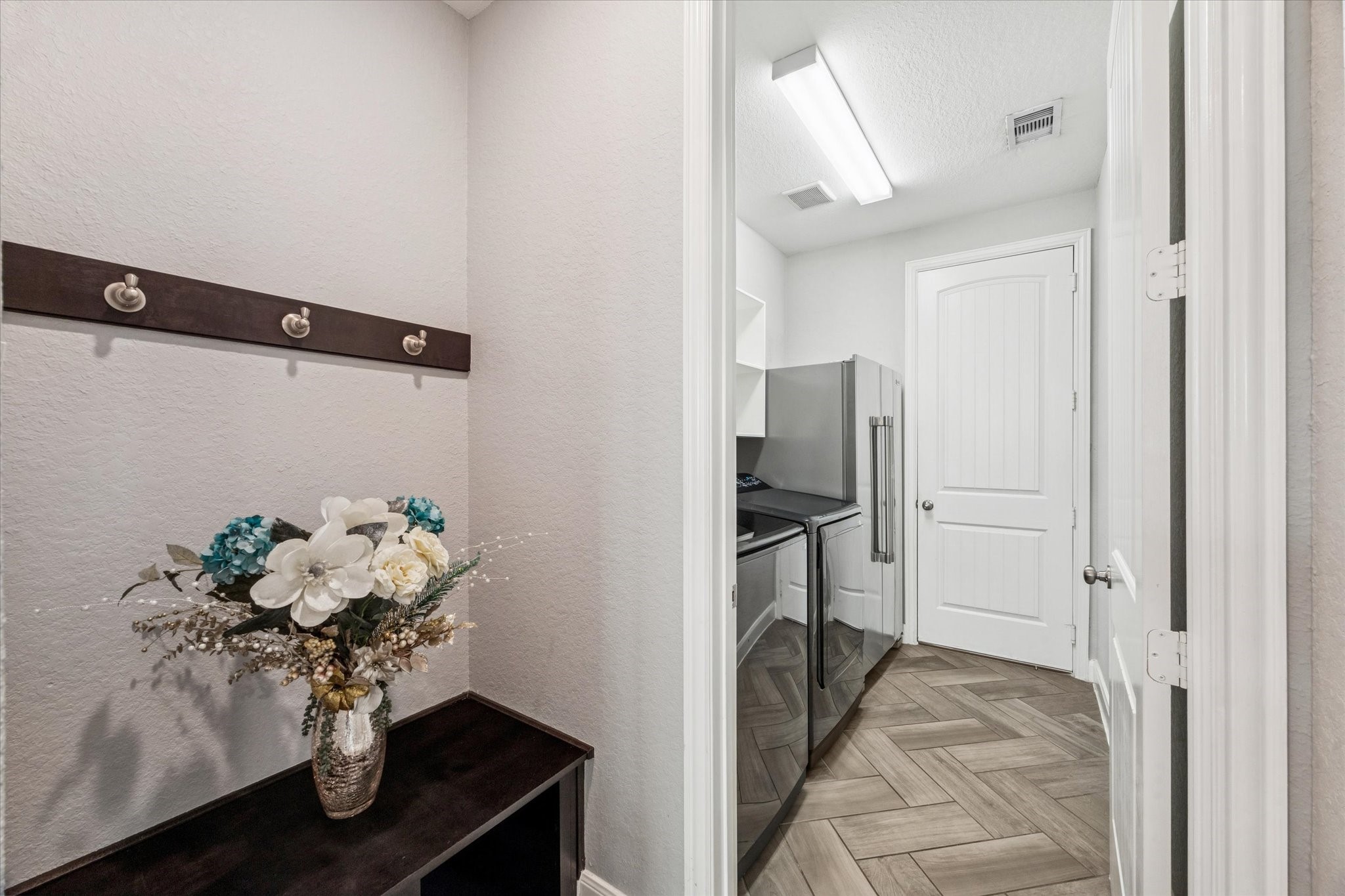 2283 Rising Bay Court League City, TX 77573 - Photo 35 of 45 a view of a hallway with wooden floor and a chandelier