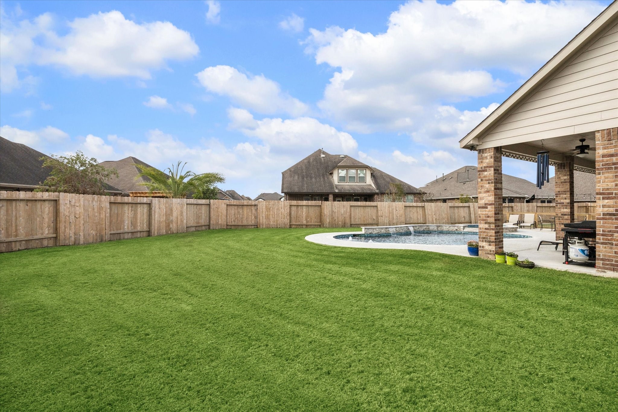 2283 Rising Bay Court League City, TX 77573 - Photo 44 of 45 a view of a backyard with table and chairs and wooden fence