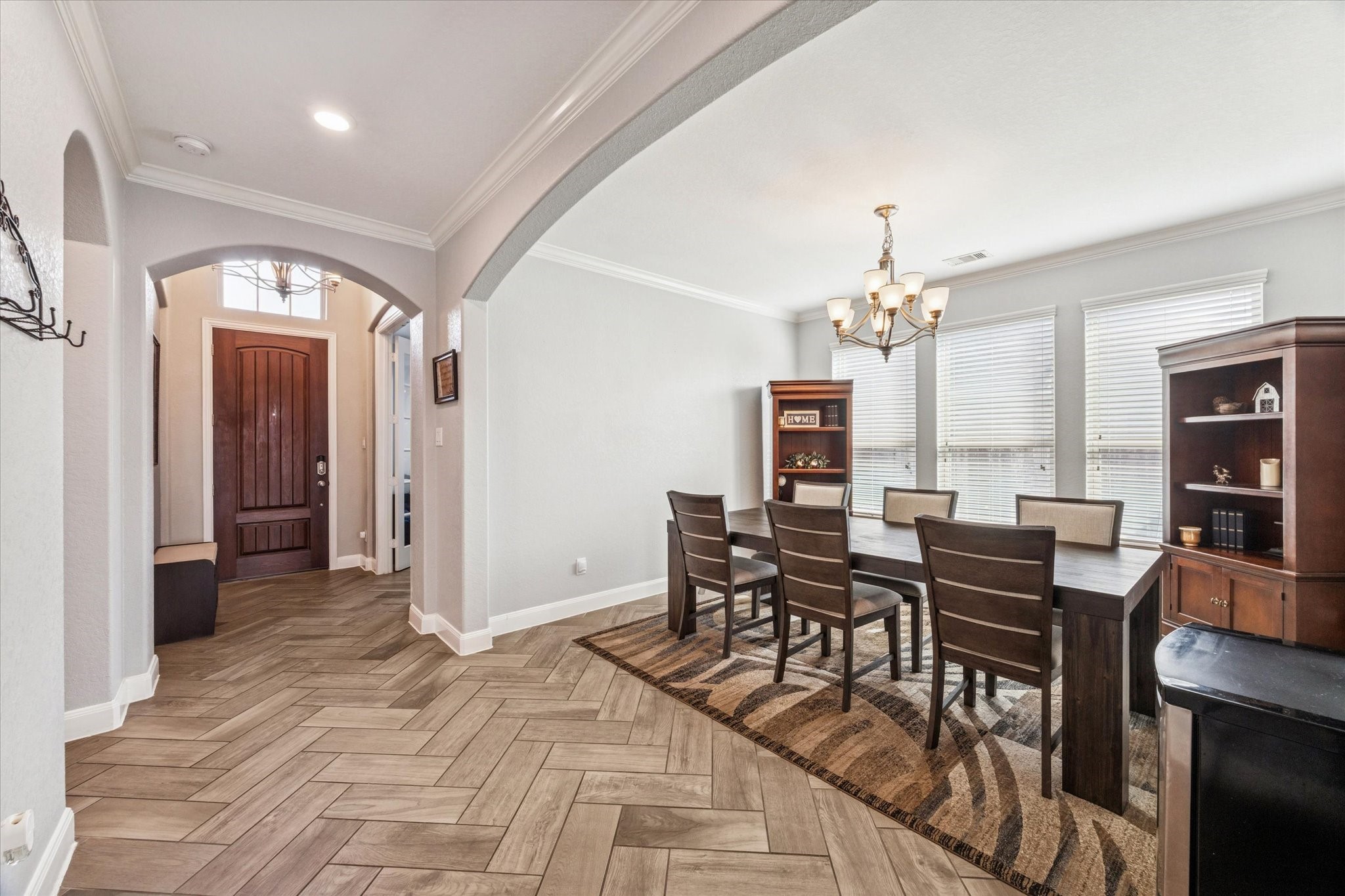 2283 Rising Bay Court League City, TX 77573 - Photo 8 of 45 a view of a dining room with furniture and chandelier