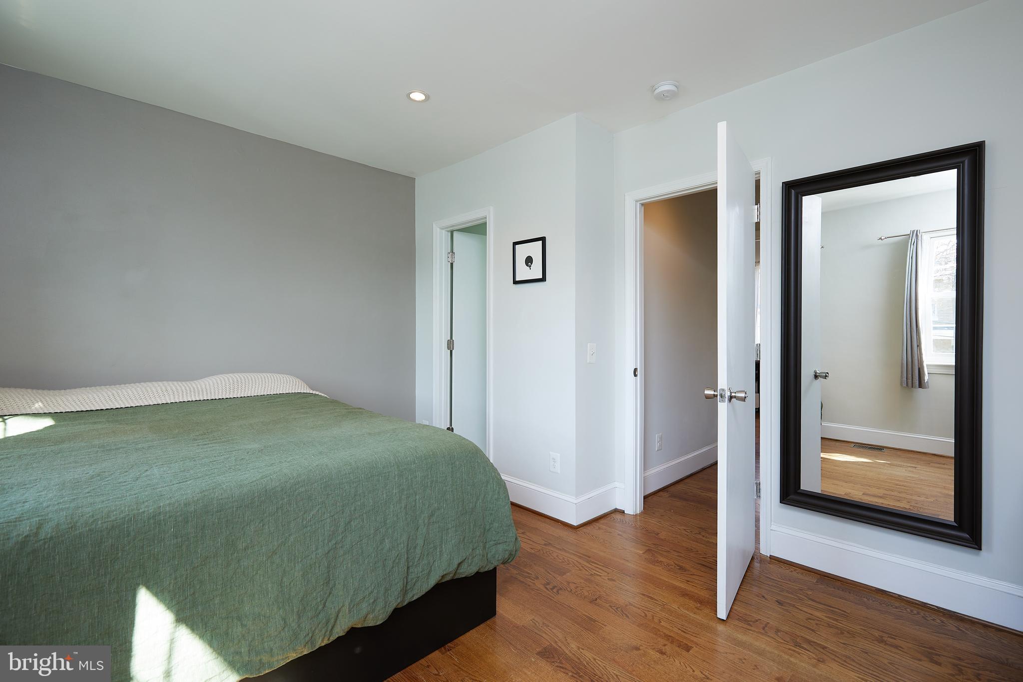 421 Longfellow Street Northwest Washington, DC 20011 - Photo 21 of 58 a bedroom with a bed and wooden floor