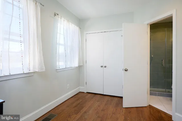 a view of a workspace with furniture and wooden floor