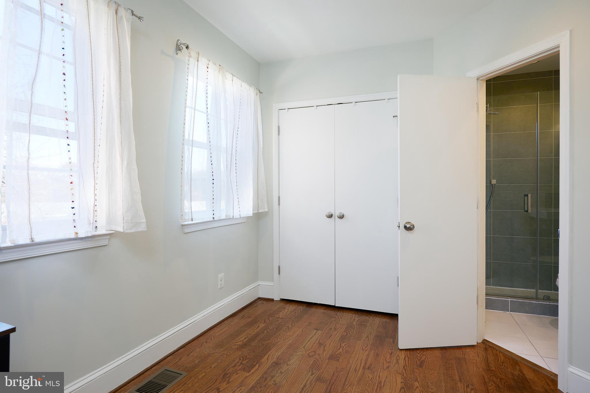 421 Longfellow Street Northwest Washington, DC 20011 - Photo 27 of 58 a view of an empty room with wooden floor and a window