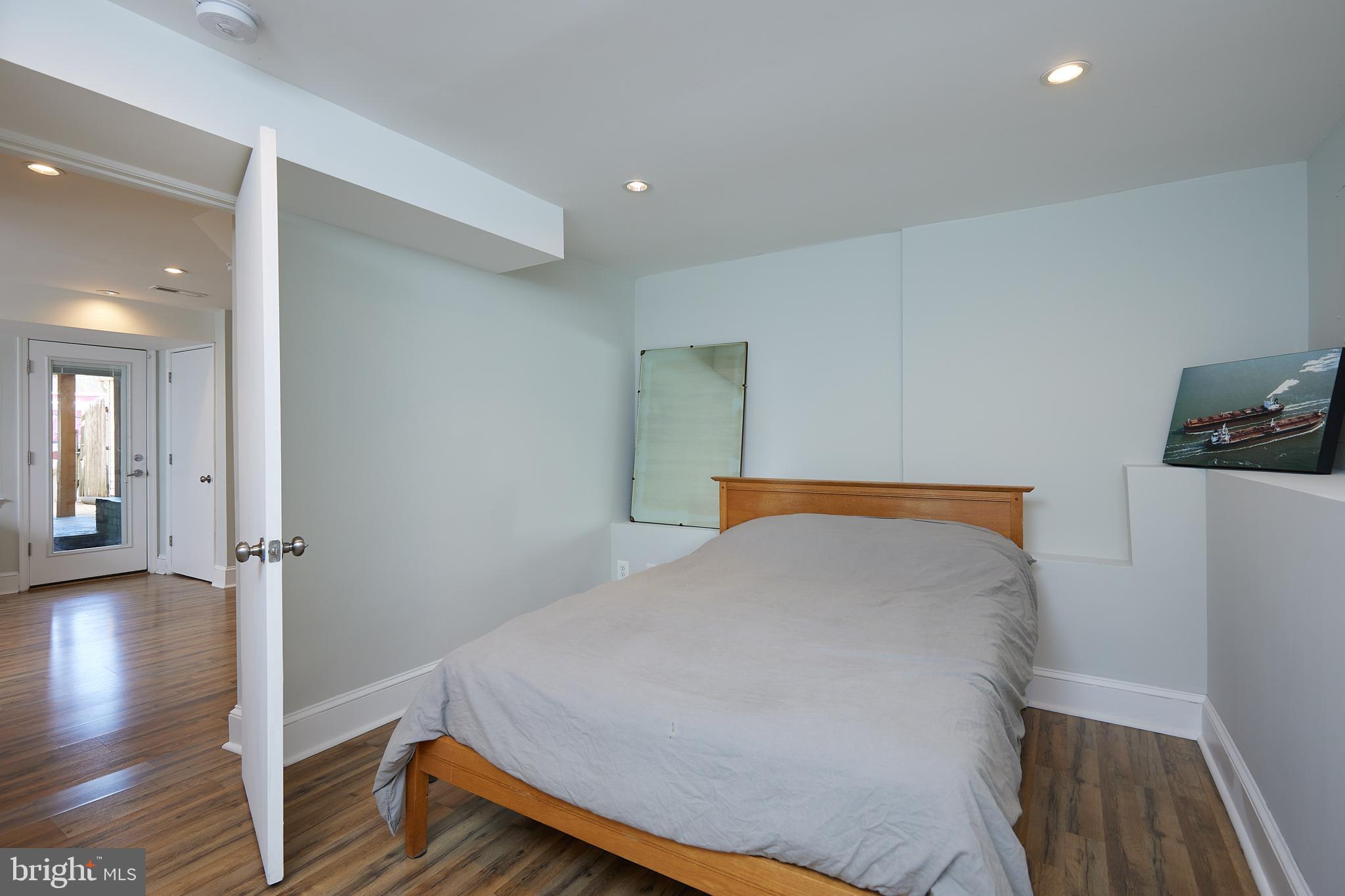 421 Longfellow Street Northwest Washington, DC 20011 - Photo 33 of 58 a bedroom with a bed and wooden floor