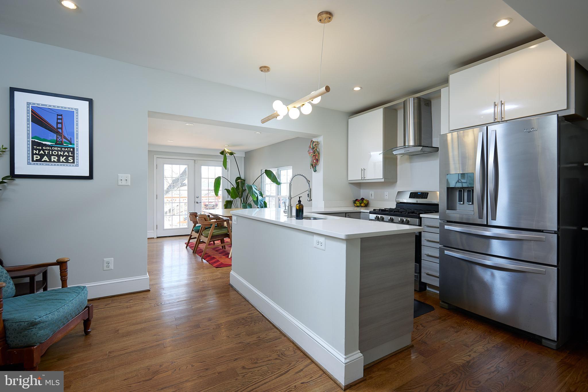 421 Longfellow Street Northwest Washington, DC 20011 - Photo 6 of 58 a kitchen with stainless steel appliances a refrigerator and wooden floor