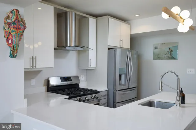 a kitchen with refrigerator and cabinets