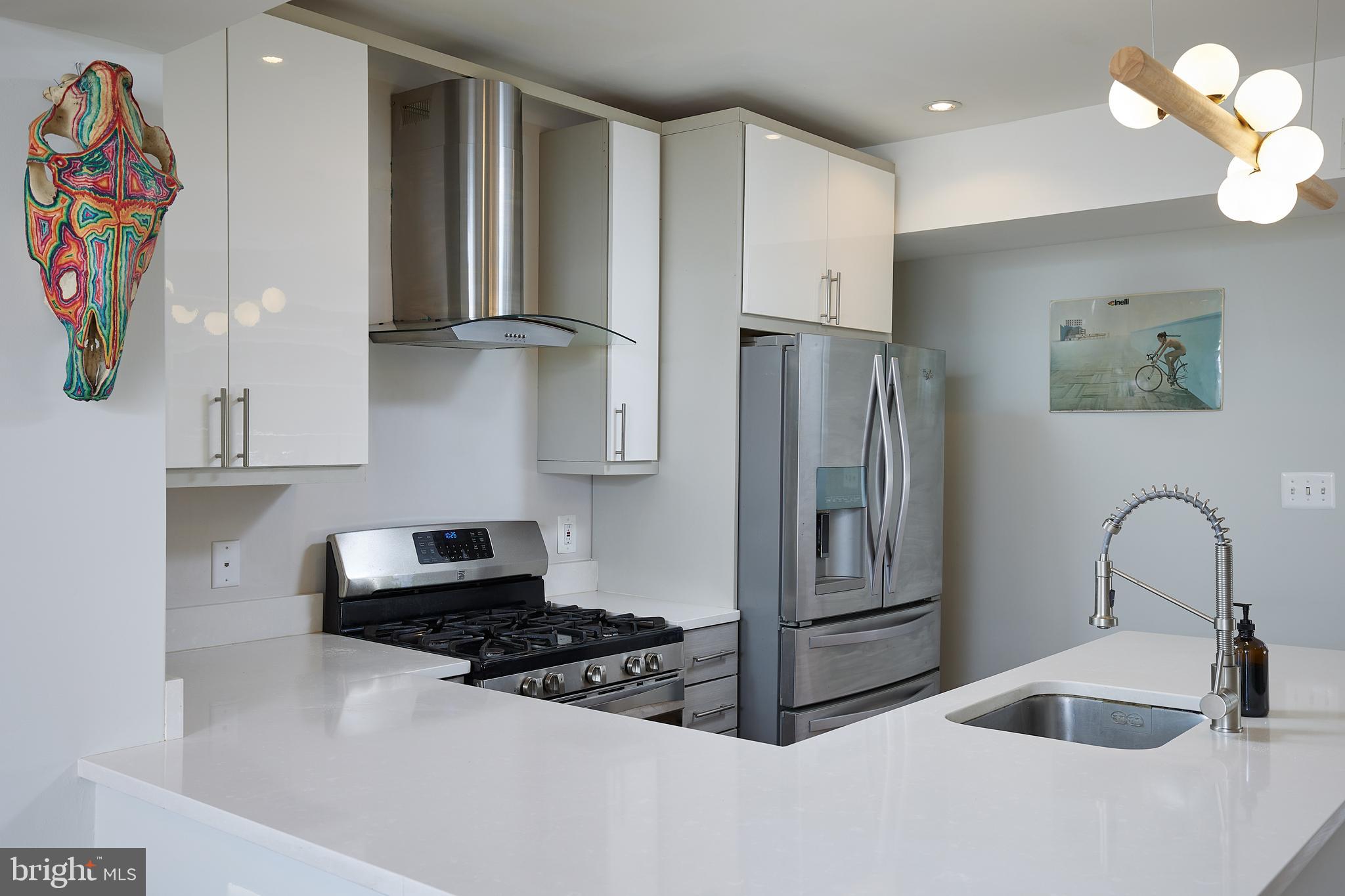 421 Longfellow Street Northwest Washington, DC 20011 - Photo 8 of 58 a kitchen with stainless steel appliances granite countertop a refrigerator and a sink