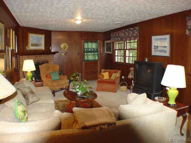 13361 Kingsmill Road Midlothian, VA 23113 - Photo 6 of 8 a living room with furniture and a lamp