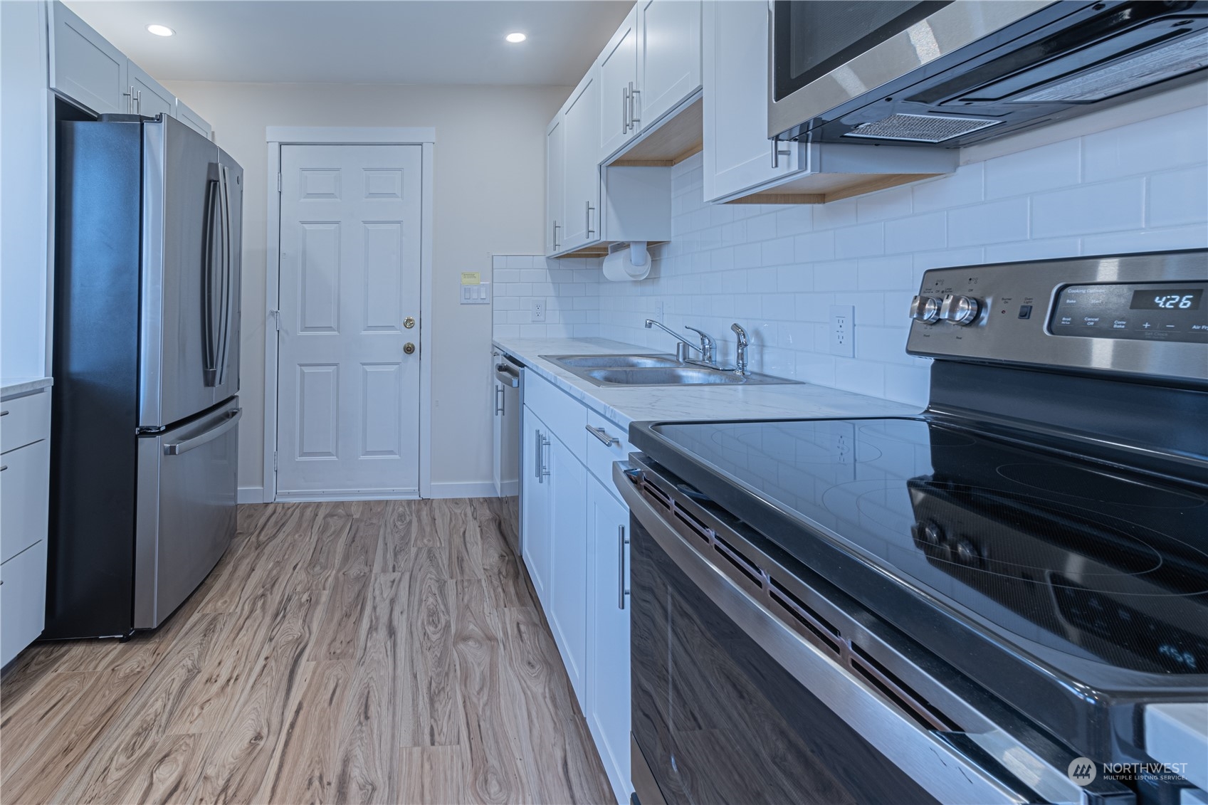 1125 Southwest 356th Street Federal Way, WA 98023 - Photo 12 of 27 a kitchen with wooden floors and appliances