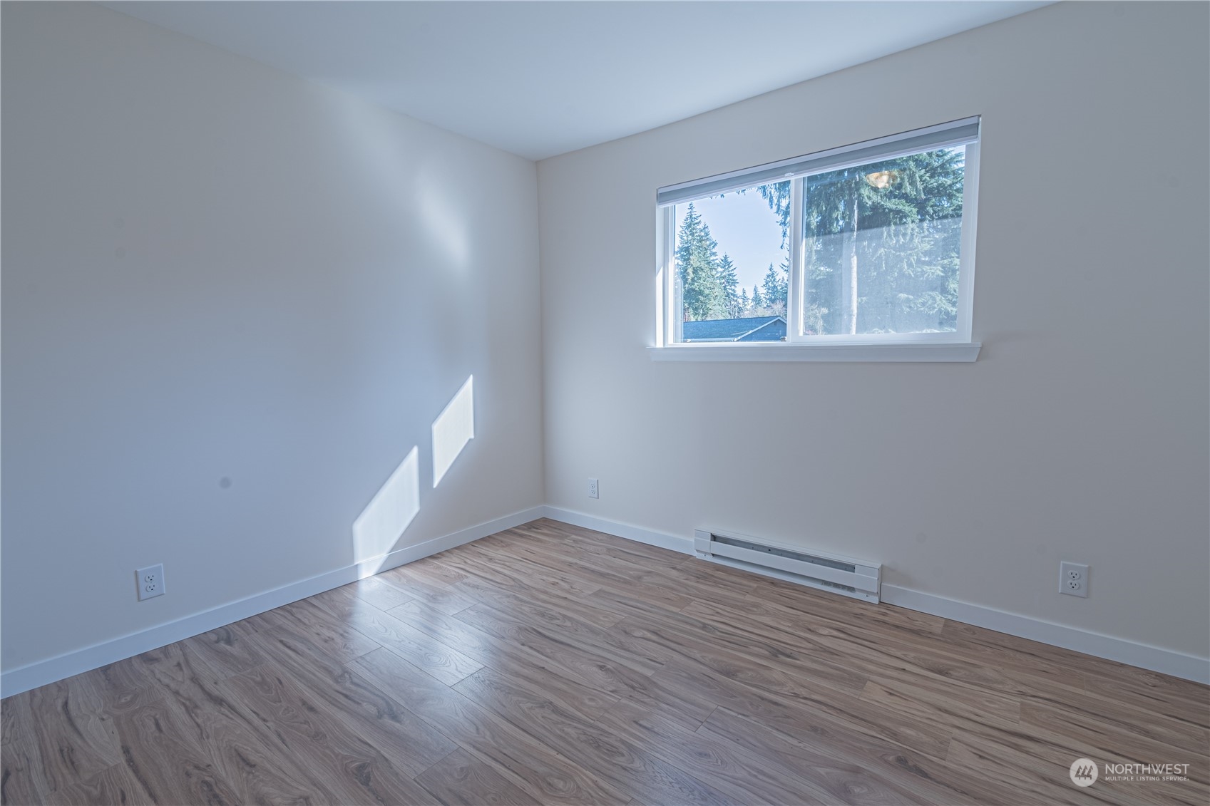 1125 Southwest 356th Street Federal Way, WA 98023 - Photo 18 of 27 a view of an empty room with wooden floor and a window