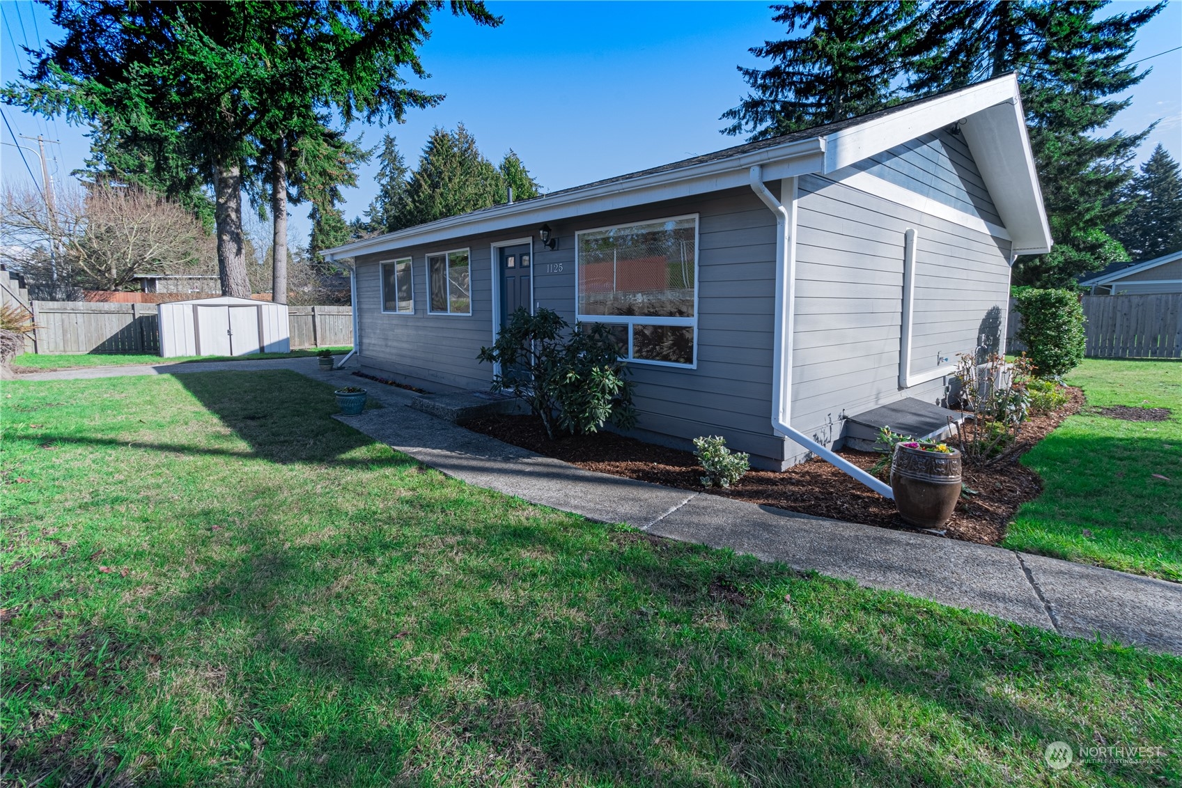 1125 Southwest 356th Street Federal Way, WA 98023 - Photo 2 of 27 a backyard of a house with table and chairs plants and large tree