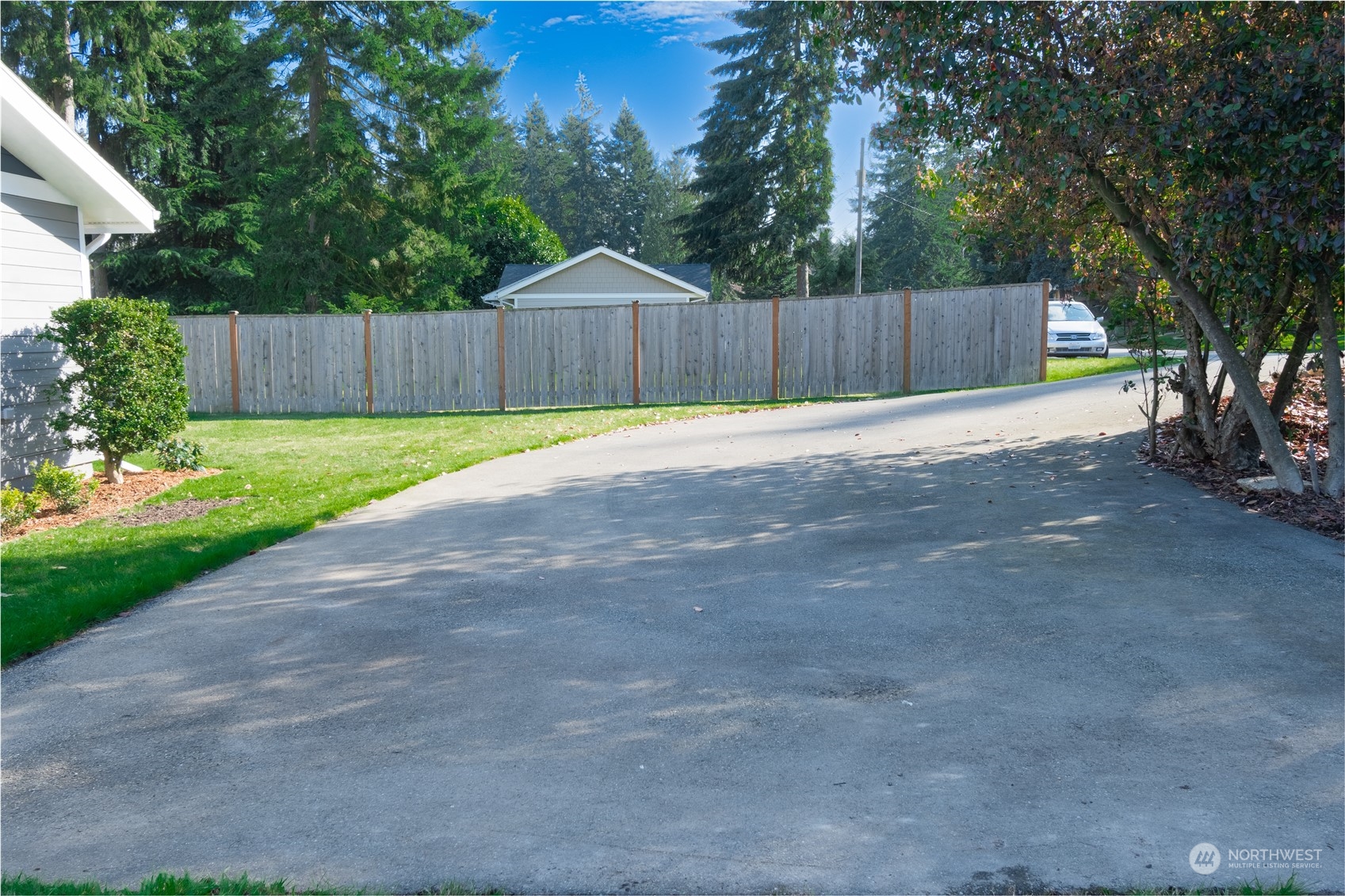 1125 Southwest 356th Street Federal Way, WA 98023 - Photo 25 of 27 a view of a backyard with large tree and wooden fence