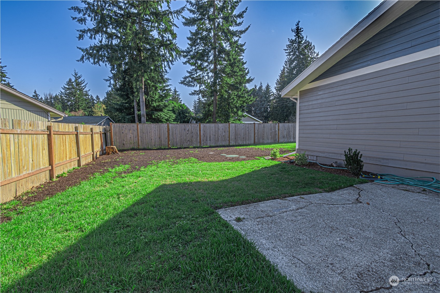 1125 Southwest 356th Street Federal Way, WA 98023 - Photo 26 of 27 a view of a backyard with potted plants and wooden fence